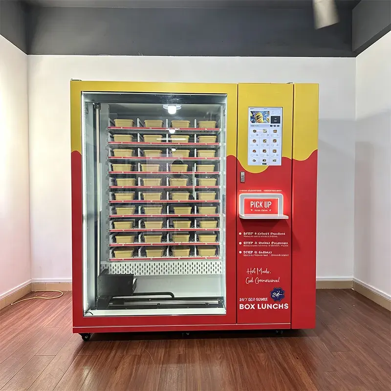 Hot meal vending machine loaded with boxed meals behind a glass cabinet